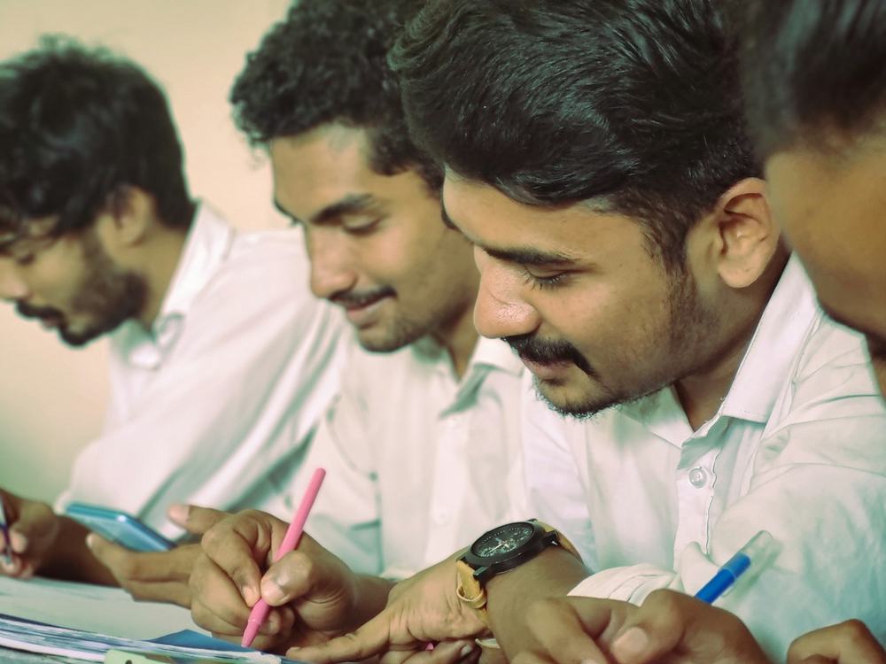 Students writing a paper-based aptitude exam